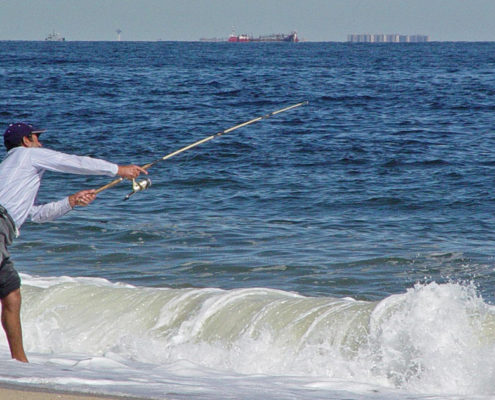 Fisherman casting off surfside