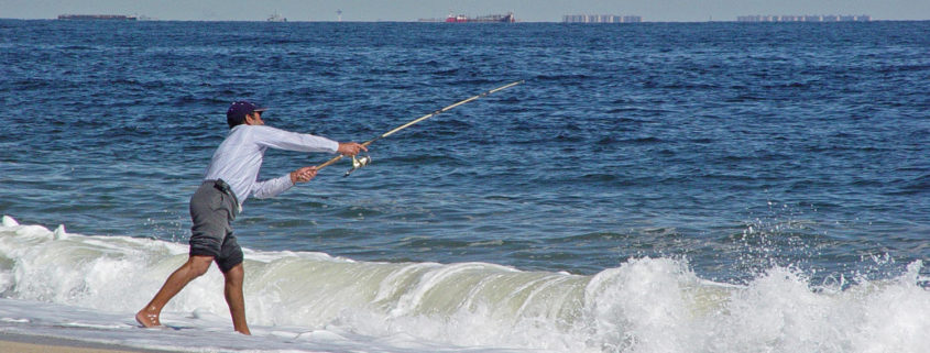 Fisherman casting off surfside